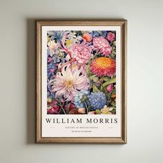 a painting hanging on the wall with flowers in it