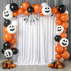 an orange and black halloween balloon arch