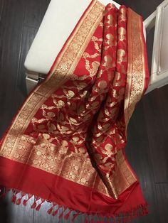 This is a beautiful bridal red pure katan silk banarasi kadwa jangla dupatta that is made for weddings!! Beautifully handwoven in golden zari, floral zari borders these floral jaal pattern on this red dupatta is truly stunning!! You just won't be able to take your eyes off it when you see it. This is a true testament to its' weaver's skill.  Don't wait! Own it today!! Length:232 cm Width:92 cm Kadwa weave requires skill and takes much longer to weave. Colour may vary slightly depending upon the Luxury Katan Silk Dupatta With Block Print, Elegant Luxury Katan Silk Dupatta, Luxury Katan Silk Block Print Dupatta, Luxury Banarasi Silk Dupatta With Weaving Work, Luxury Katan Silk Dupatta, Luxury Banarasi Silk Pashmina Shawl With Zari Weaving, Luxury Katan Silk Dupatta For Rituals, Luxury Banarasi Silk Dupatta With Printed Motifs, Luxury Katan Silk Lehenga With Zari Weaving