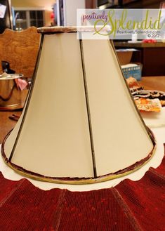 a lamp shade sitting on top of a table next to a cupcakes and muffins