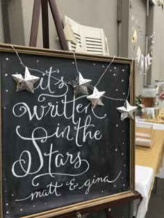 a chalkboard sign that says it's written in the stars