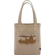 a tote bag that says patagon save our home planet with mountains in the background