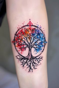 a colorful tree tattoo on the right thigh with an arrow in it's center