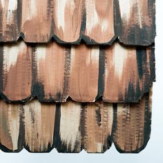 a close up of a roof with brown and white paint