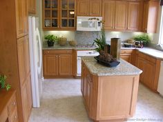 a kitchen with wooden cabinets and white appliances