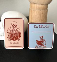 two playing cards sitting on top of a table next to a ball and a wooden mallet