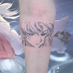 a tattoo on the leg of a person with an anime character in the sky behind them