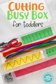 some scissors and other crafting supplies in a plastic container with the words cutting busy box for toddlers