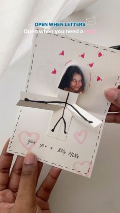 someone is holding up a card with an image on it