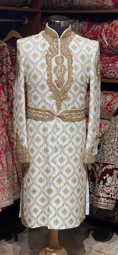 Mesmerize the crowd by your magnificent gaze in this off white pure raw silk fabricated wedding sherwani crafted in zardosi,bead,stone,resham & zari work with details embroidered waist belt. Available with matching bottoms chudidar. Size: 38,44 Ready to Ship! Ceremonial Clothing, Embroidered Sherwani, Wedding Sherwani, Zari Work, Extra Fabric, Churidar, Wedding Looks, Raw Silk, Waist Belt