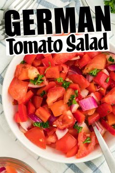 a white bowl filled with tomato salad next to a fork and knife on top of a checkered table cloth