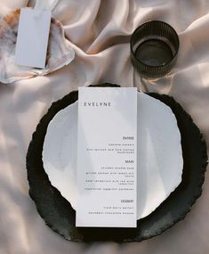 an empty menu sitting on top of a black plate