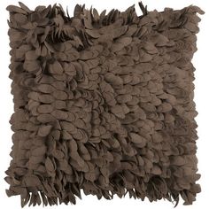 a brown pillow with large leaves on it