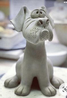 a ceramic dog figurine sitting on top of a table