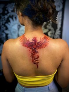 a woman with a bird tattoo on her back