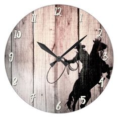 a wooden wall clock with a horse and rider silhouette on the front, against a white background