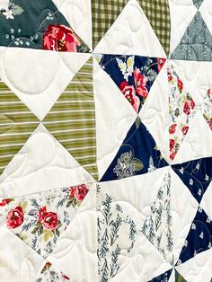 a close up view of a quilt with flowers on it