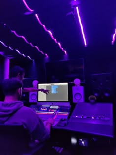 a man sitting in front of a mixing desk