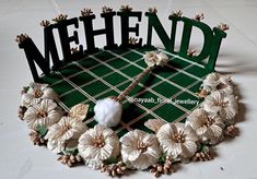 the word mehnd is made out of paper and flowers