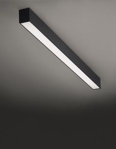 an overhead light fixture in a dark room