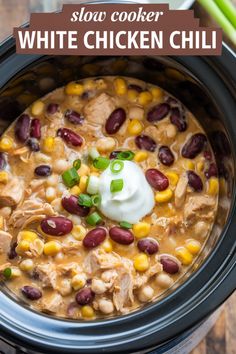 White chicken chili in a slow cooker topped with sour cream and green onions. Crockpot Ideas With Chicken, Crock Pot Heart Healthy Meals, White Bean Chili Chicken Crockpot, White Chicken Chili With Ranch Packet, Crockpot Chicken Chilli Recipes, White Chicken Chili With Black Beans, Healthy White Chicken Chili Slow Cooker, White Bean Chicken Chili Stovetop, White Chicken Chili Slow Cooker Healthy