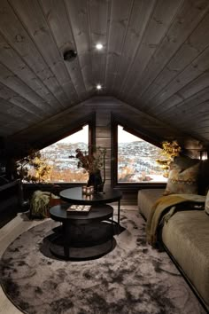 a living room filled with furniture and a round table on top of a shaggy rug