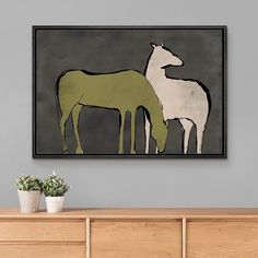 two horses standing next to each other on a wall