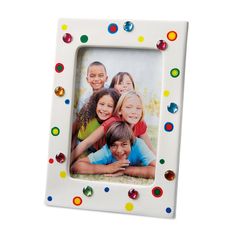 a white photo frame with multicolored dots on the front and sides is shown