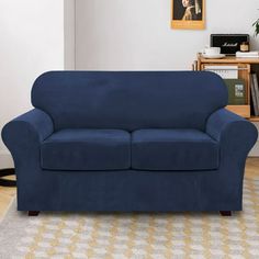 a blue couch sitting on top of a wooden floor