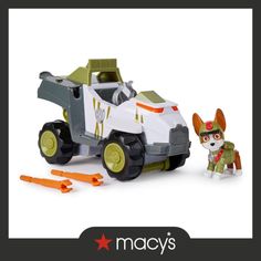 a toy car with a dog next to it and an advertisement for macy's