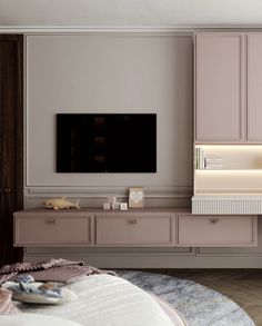 a living room with pink furniture and a flat screen tv mounted on the wall above it