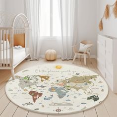 a baby's room with a white crib and map rug on the floor