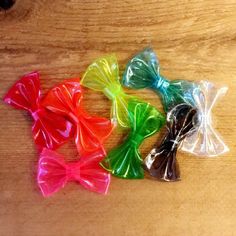 four different colored bows sitting on top of a wooden table