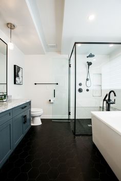 a bathroom with black and white tile flooring