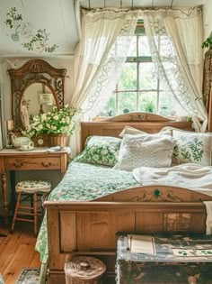 a bed sitting under a window next to a wooden dresser and table with flowers on it