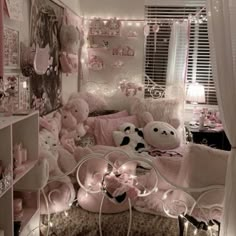 a room filled with lots of stuffed animals and pink decorations on the wall above it