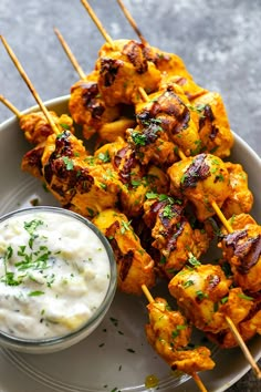 chicken skewers with ranch dressing on a plate