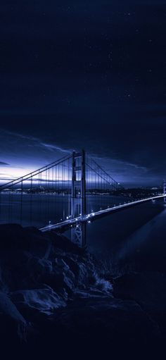 the golden gate bridge is lit up at night