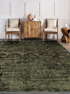 a green rug in a living room with two chairs