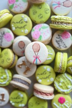 there are many decorated macaroons on the table