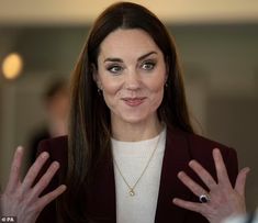 a woman with long hair wearing a black jacket and holding her hands out to the side