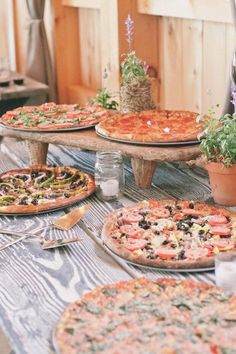 several pizzas are sitting on the table ready to be served