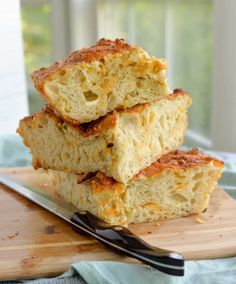 three pieces of bread sitting on top of a cutting board