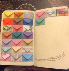 an open book with many different colored envelopes