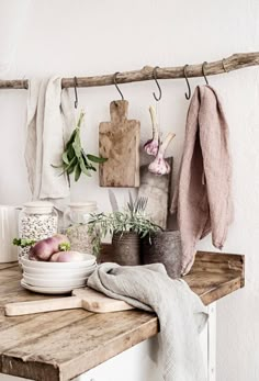 a wooden table topped with pots and pans