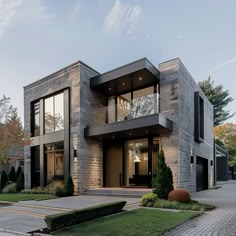 a modern house with large windows and landscaping