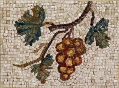 an artistic mosaic with grapes and leaves on it's side, in the shape of a tree branch