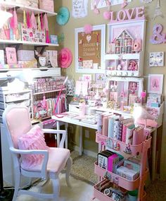 a room filled with lots of pink and white items on shelves next to a desk