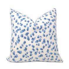 a blue and white leopard print pillow on a white background