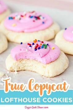 some cookies with pink frosting and sprinkles